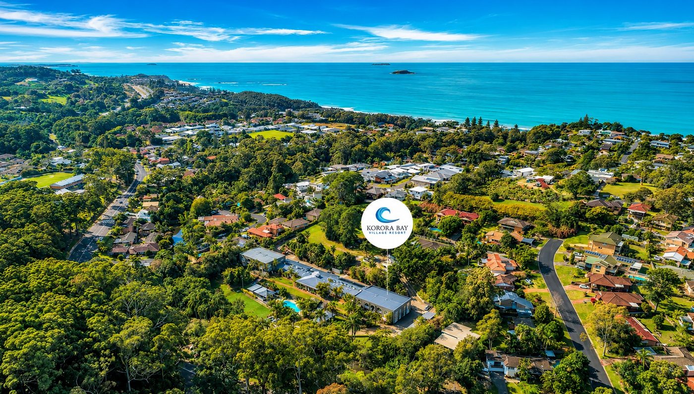 Aerial view of Korora Bay Village Resort with ocean backdrop