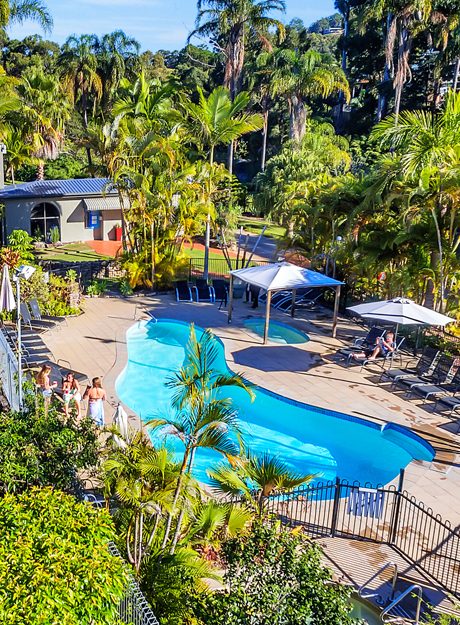 Families enjoying the pool and resort grounds at Korora Bay Village Resort