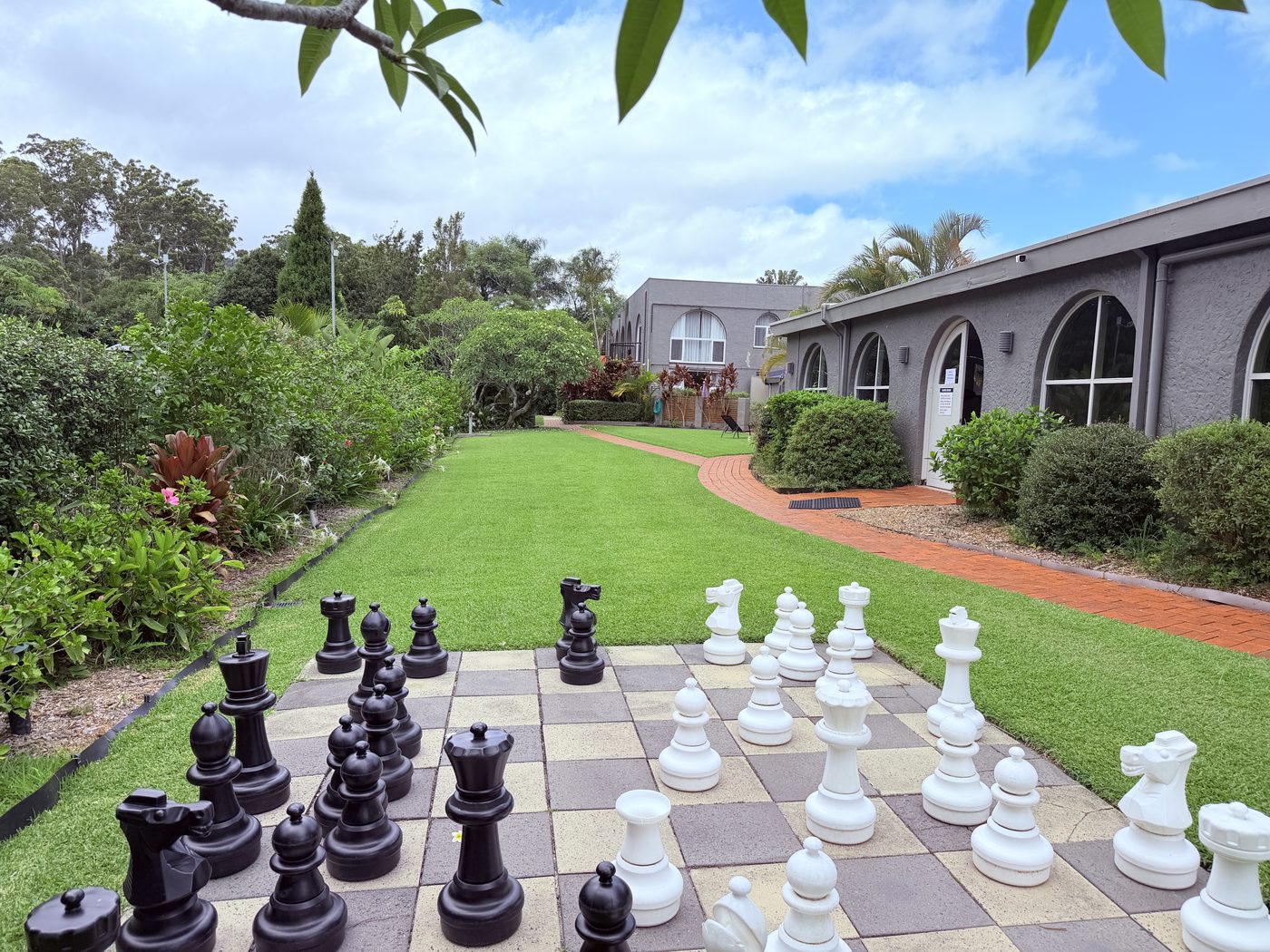 Giant outdoor chess set in the gardens at Korora Bay Village Resort