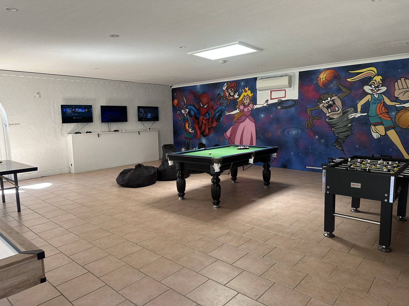 Xbox and PlayStation consoles in the media room at Korora Bay Village Resort